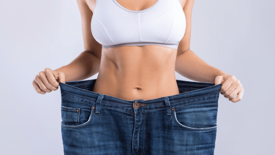 Woman holding up her oversized pants